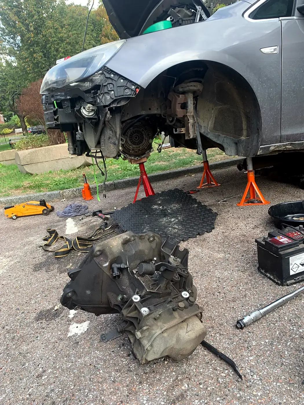 Gearbox removed for a clutch replacement on a driveway